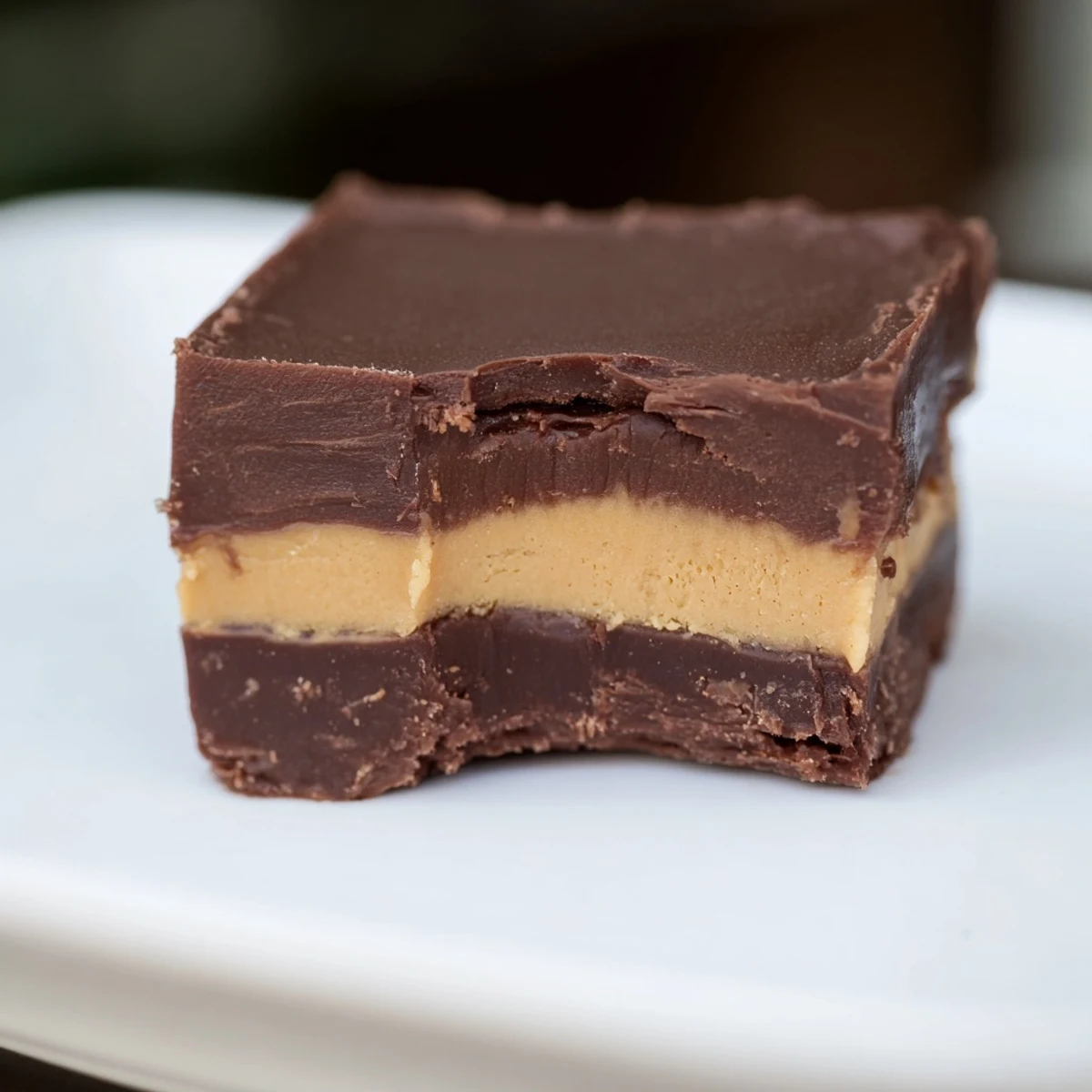 Rich, layered Chocolate Peanut Butter Fudge cut into bite-sized squares with a creamy, fudgy texture.