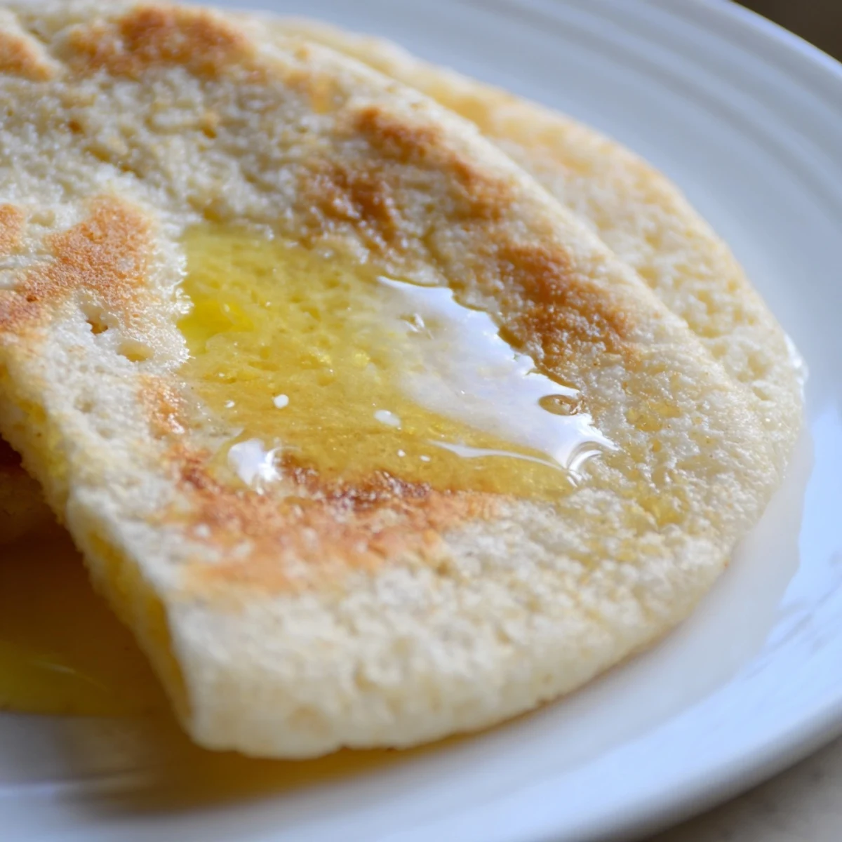 Freshly baked Irish Soda Farls with Butter, steam rising from the golden crust.