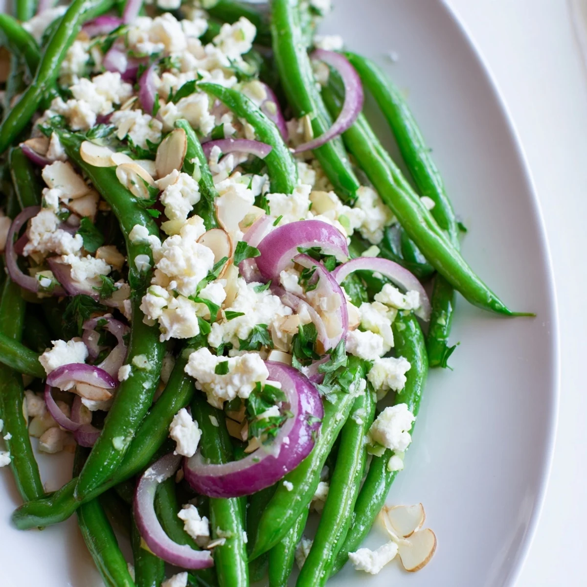 Crisp green beans, tangy feta, and toasted almonds shine in this vibrant Green Bean Salad with Feta and Almonds.