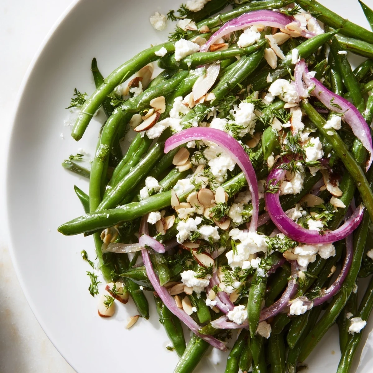 A chilled Mediterranean side, this Green Bean Salad with Feta and Almonds features lemony dressing and crunchy almonds.