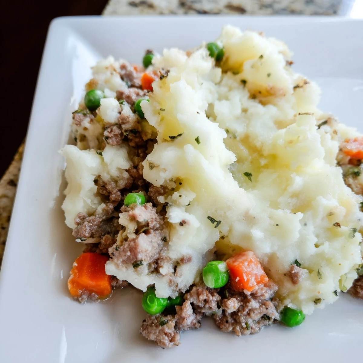 Golden mashed potatoes cover a bubbling beef and pea casserole in this classic Beef Shepherds Pie with Peas.