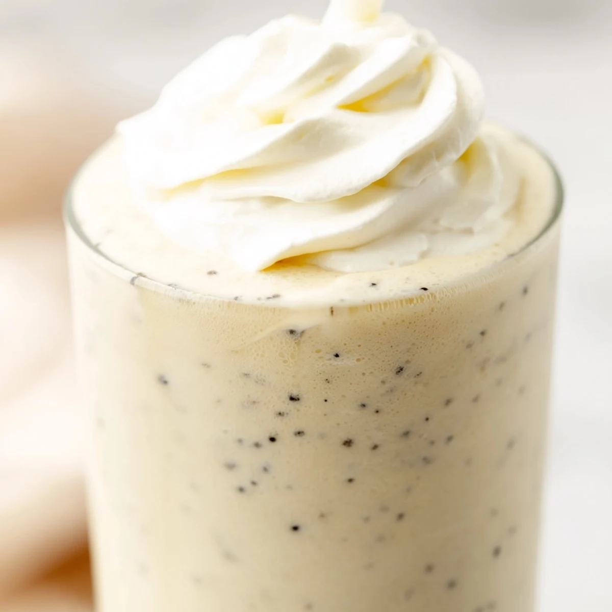 Close-up of a Starbucks Vanilla Bean Frappuccino showing creamy texture and vanilla bean specks, perfect for warm days.
