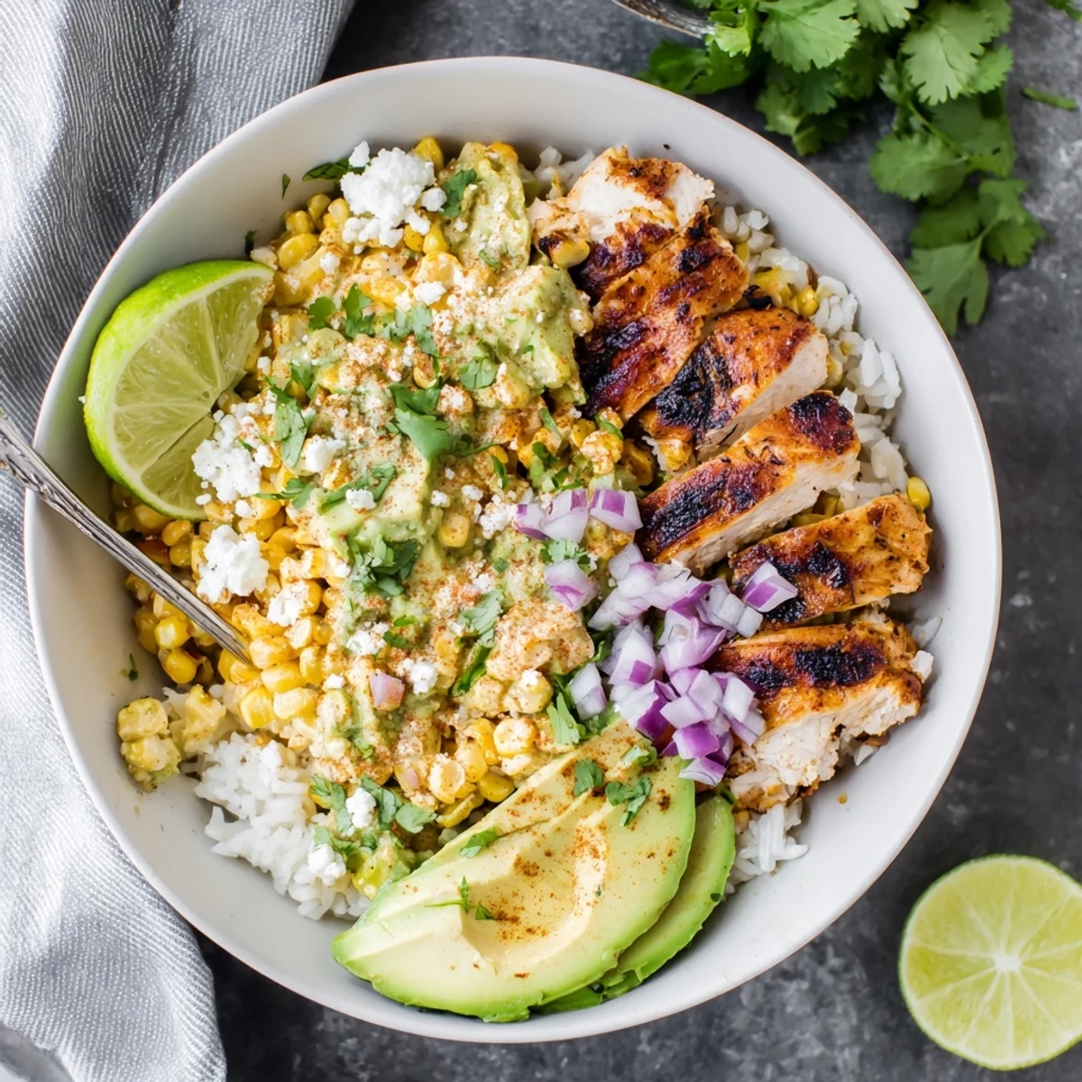 Colorful street corn chicken rice bowl featuring grilled spiced chicken with creamy Mexican corn