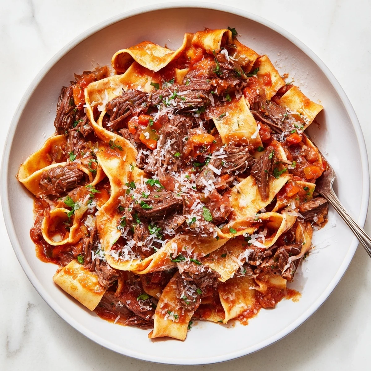 Hearty slow cooked lamb ragu with pappardelle tossed in velvety red wine and tomato sauce with fresh herbs.