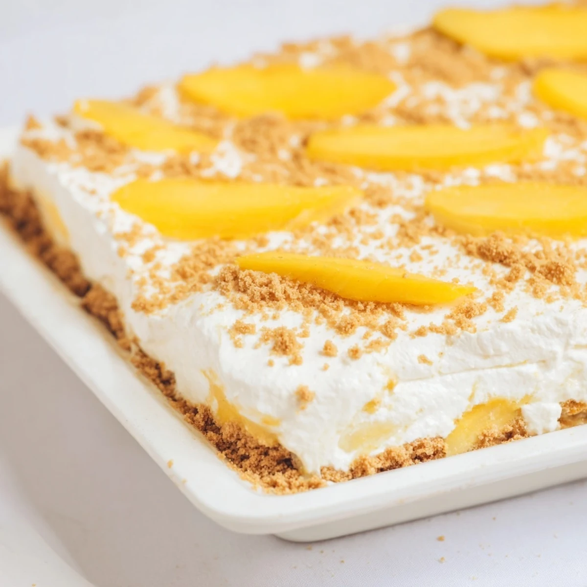 Golden layers of ripe mango slices nestled between sweetened cream and graham crackers in this Filipino mango float