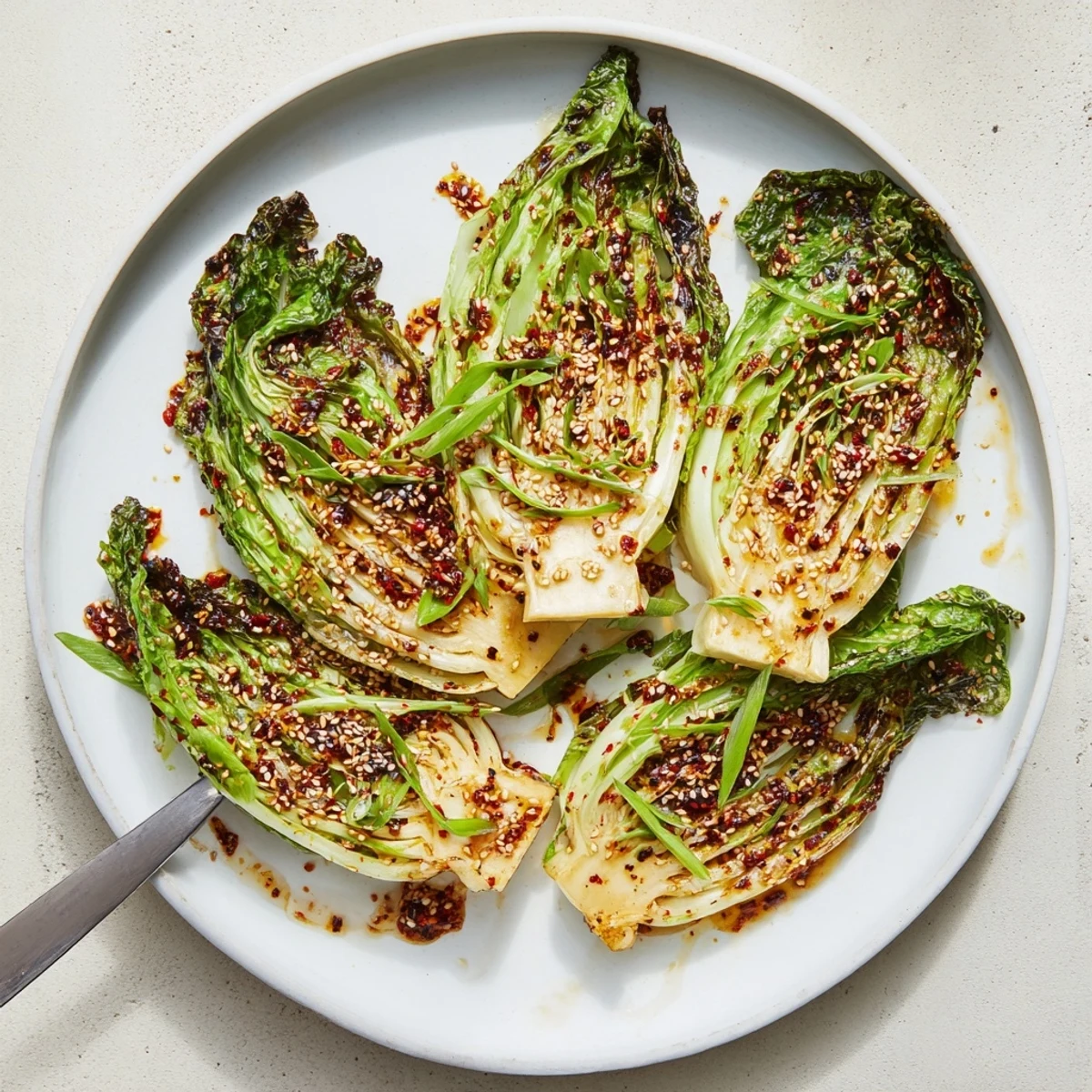 Golden roasted miso butter cabbage wedges drizzled with savory umami sauce and sesame seeds