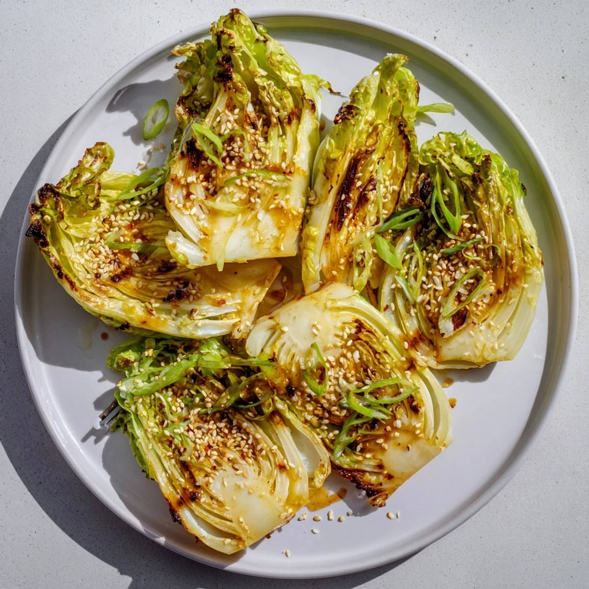 Tender cabbage wedges caramelized to perfection with miso garlic butter glaze on a baking sheet