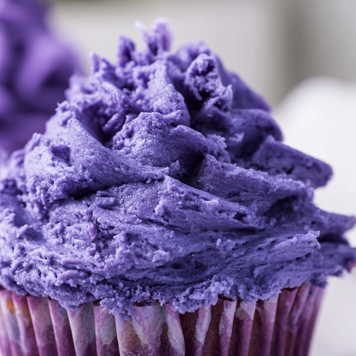 Close up of vibrant grape soda cupcakes with tangy grape frosting and decorative sprinkles