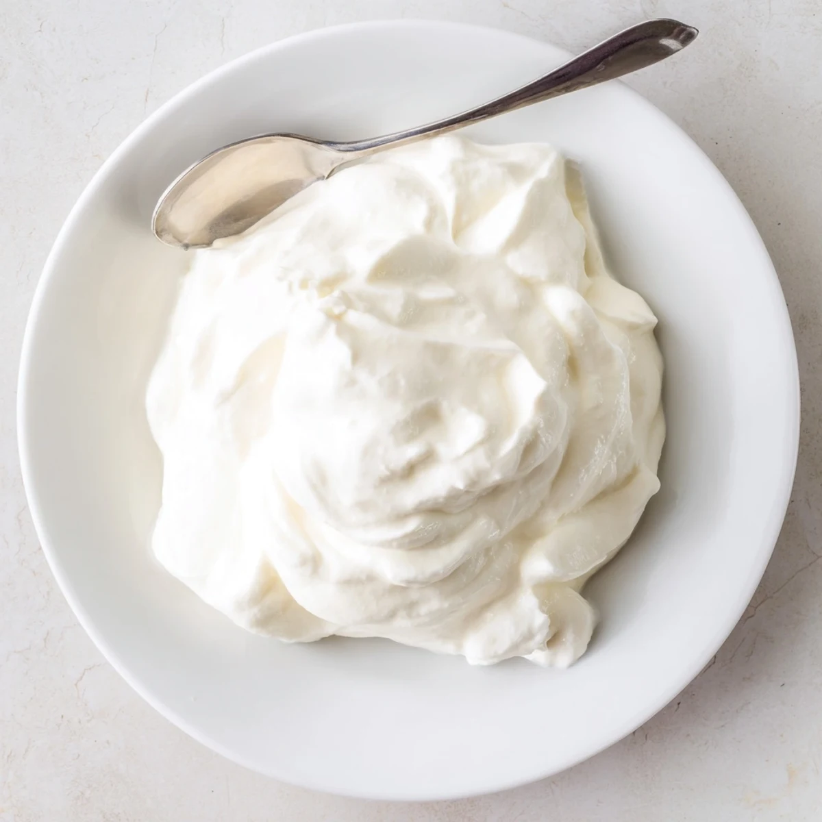 Homemade Greek yogurt bowl topped with fresh honey, granola, and ripe berries for breakfast
