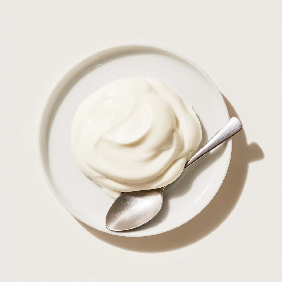 Tangy homemade Greek yogurt dollop topped with walnuts and honey on wooden serving board