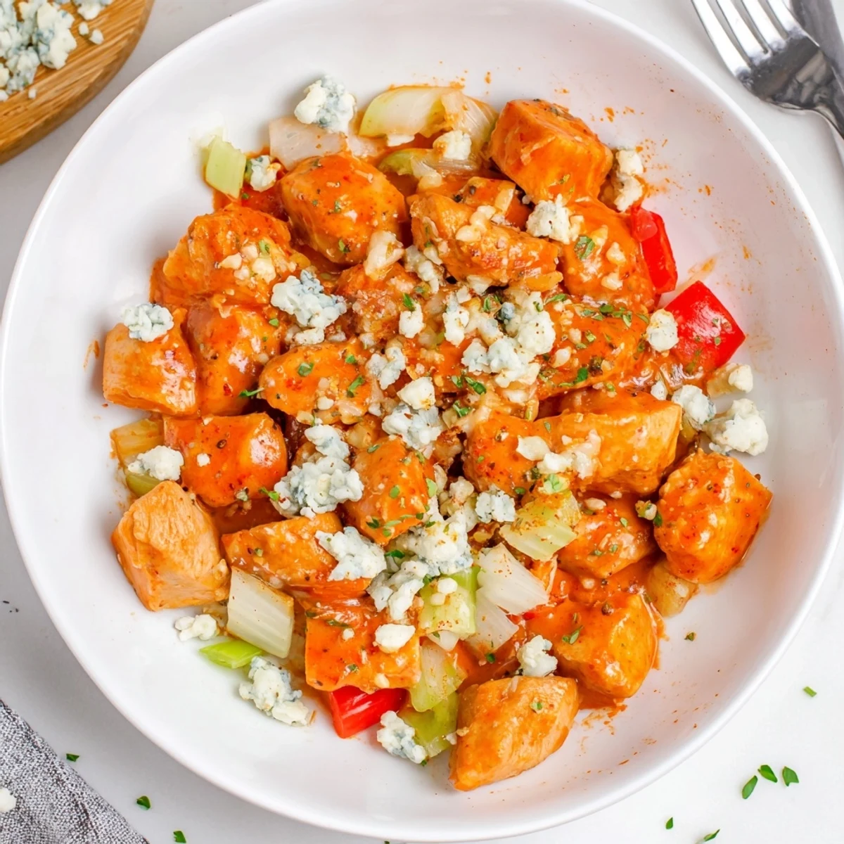 Golden seared Keto Buffalo Chicken Skillet with softened peppers, celery, and rich sauce