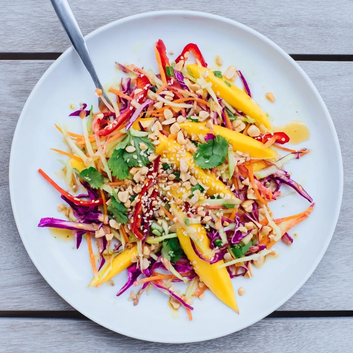 Colorful refreshing mango slaw with crunchy cabbage carrots and bright lime dressing