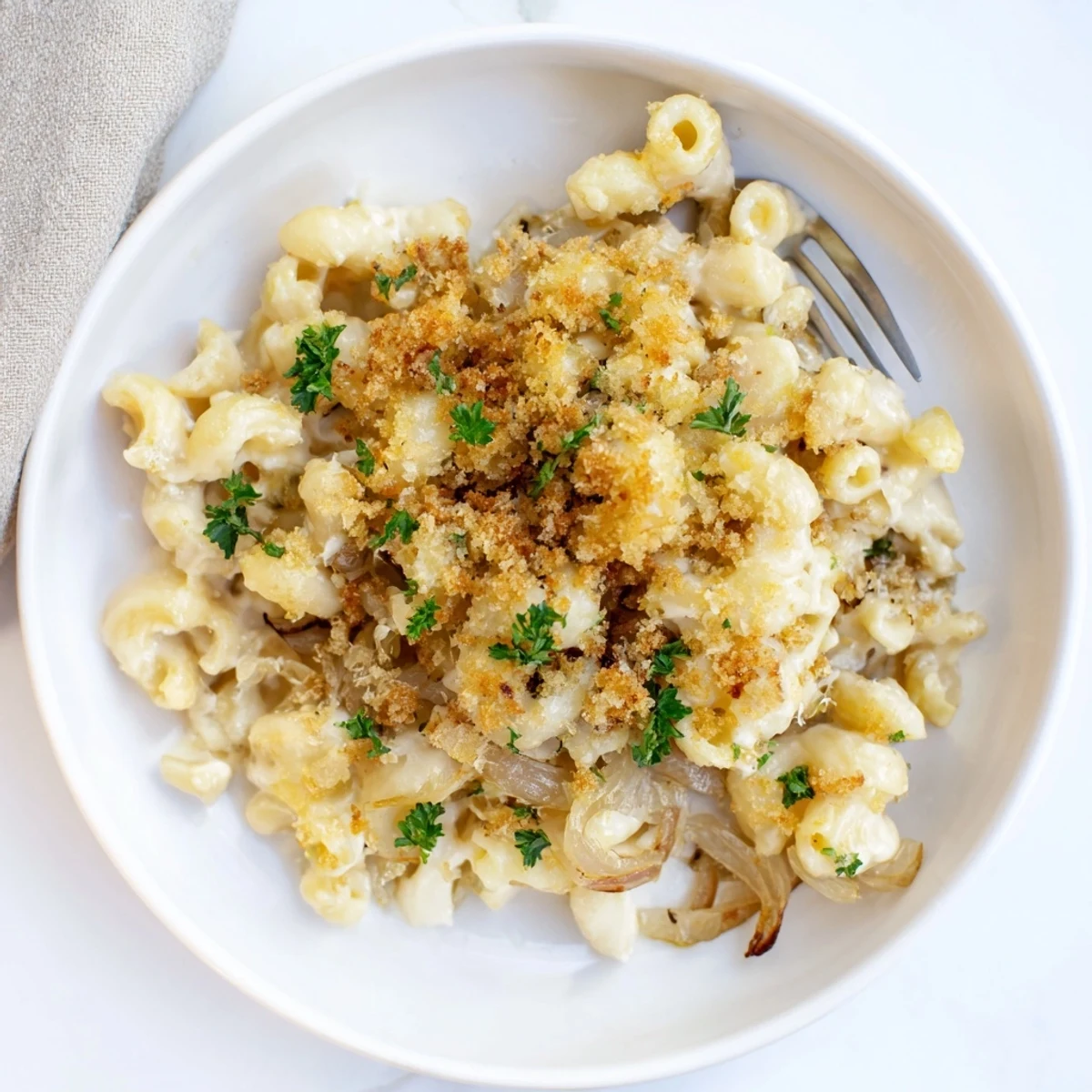 Creamy French onion mac and cheese bubbling with golden Gruyère and caramelized onion topping