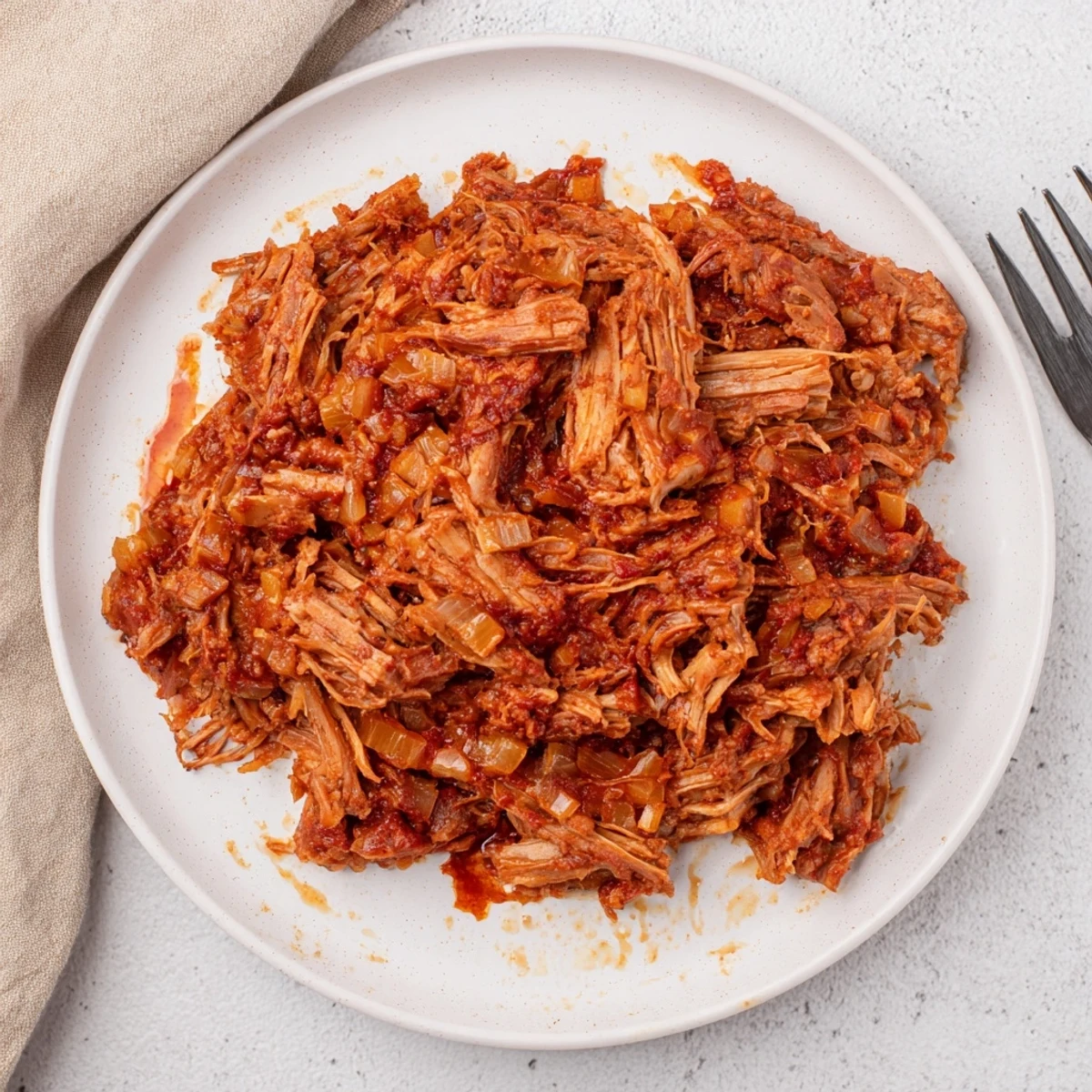 Slow cooker beef barbacoa with steam rising, perfectly tender meat ready for taco night