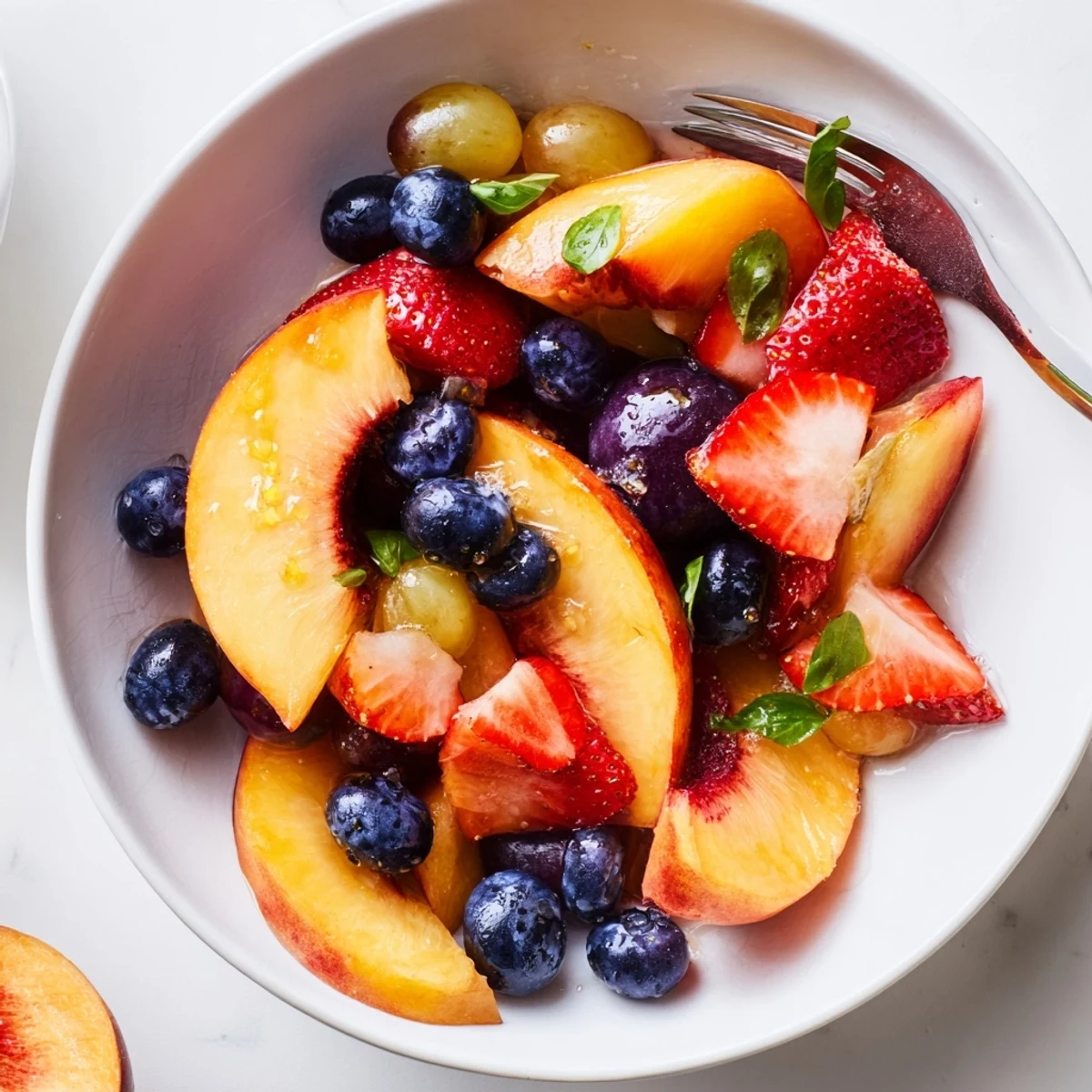 Honey Lime Basil Peach Fruit Salad glistening with honey, lime zest, picnic-ready.