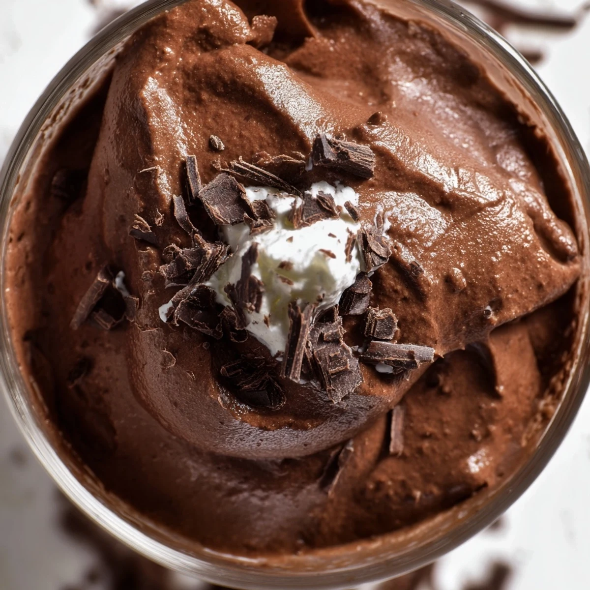 Creamy chocolate mousse served in elegant glasses topped with chocolate shavings