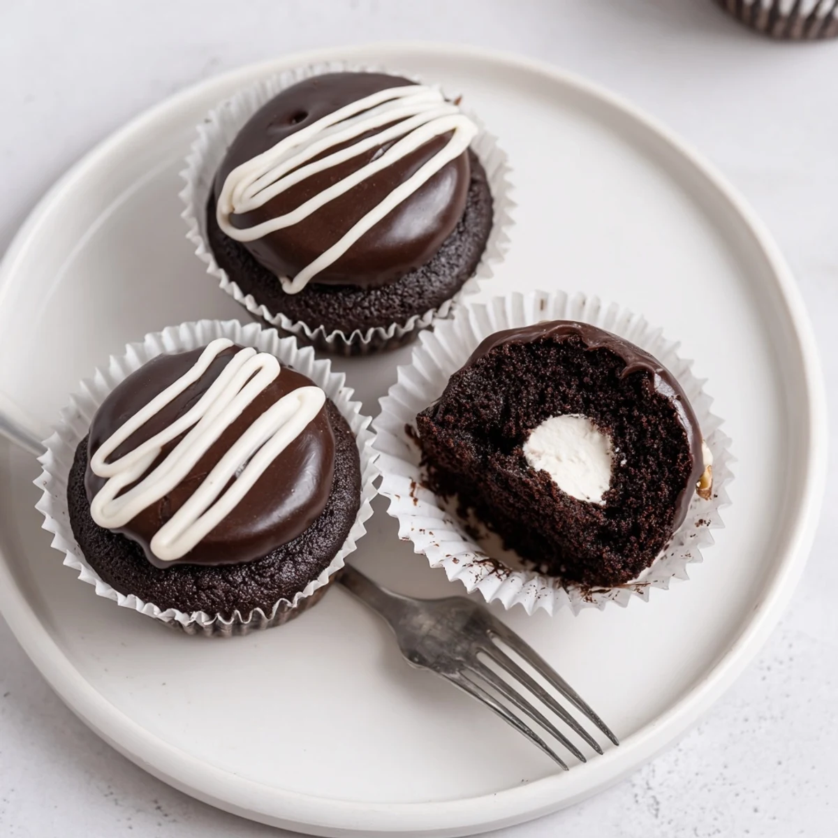 Homemade Hostess Cupcakes with glossy ganache topping and pillowy marshmallow filling
