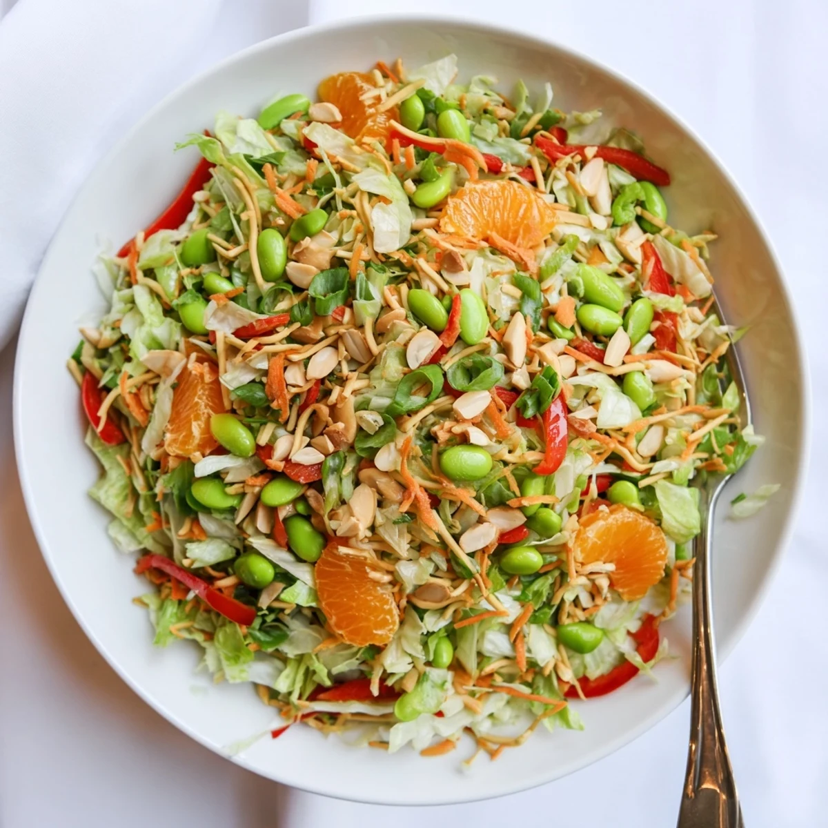 Crispy noodles and toasted almonds top this colorful Mandarin Sesame Crunch Salad