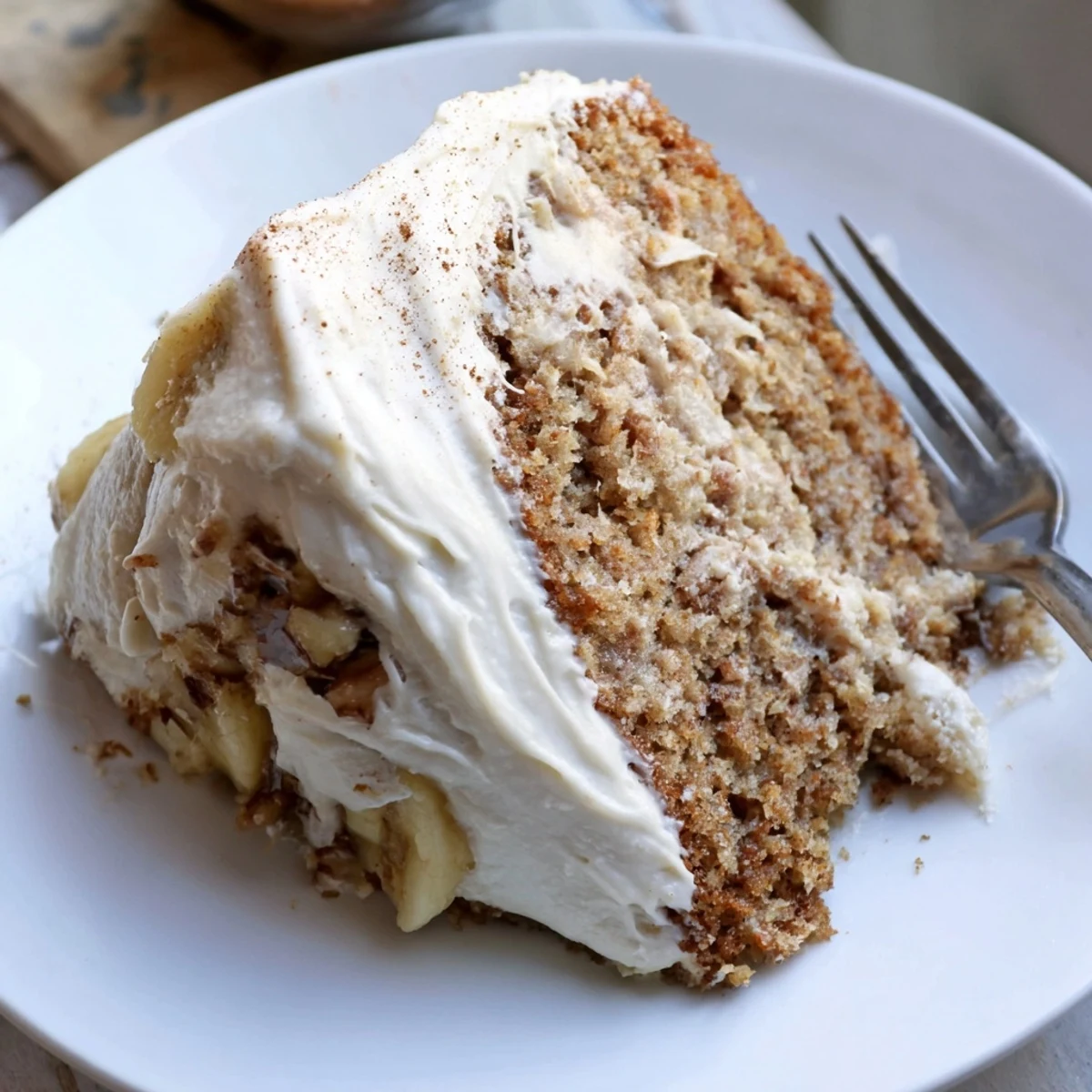 A moist Brown Butter Banana Cake topped with pillowy cream cheese frosting cut into squares